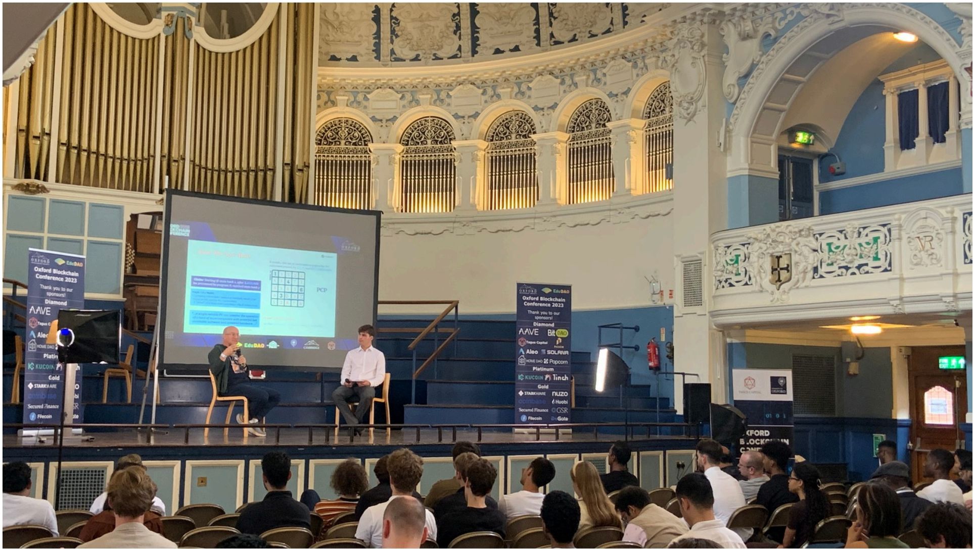 A fireside chat on the main stage at Oxford Town Hall during the Oxford Blockchain Conference